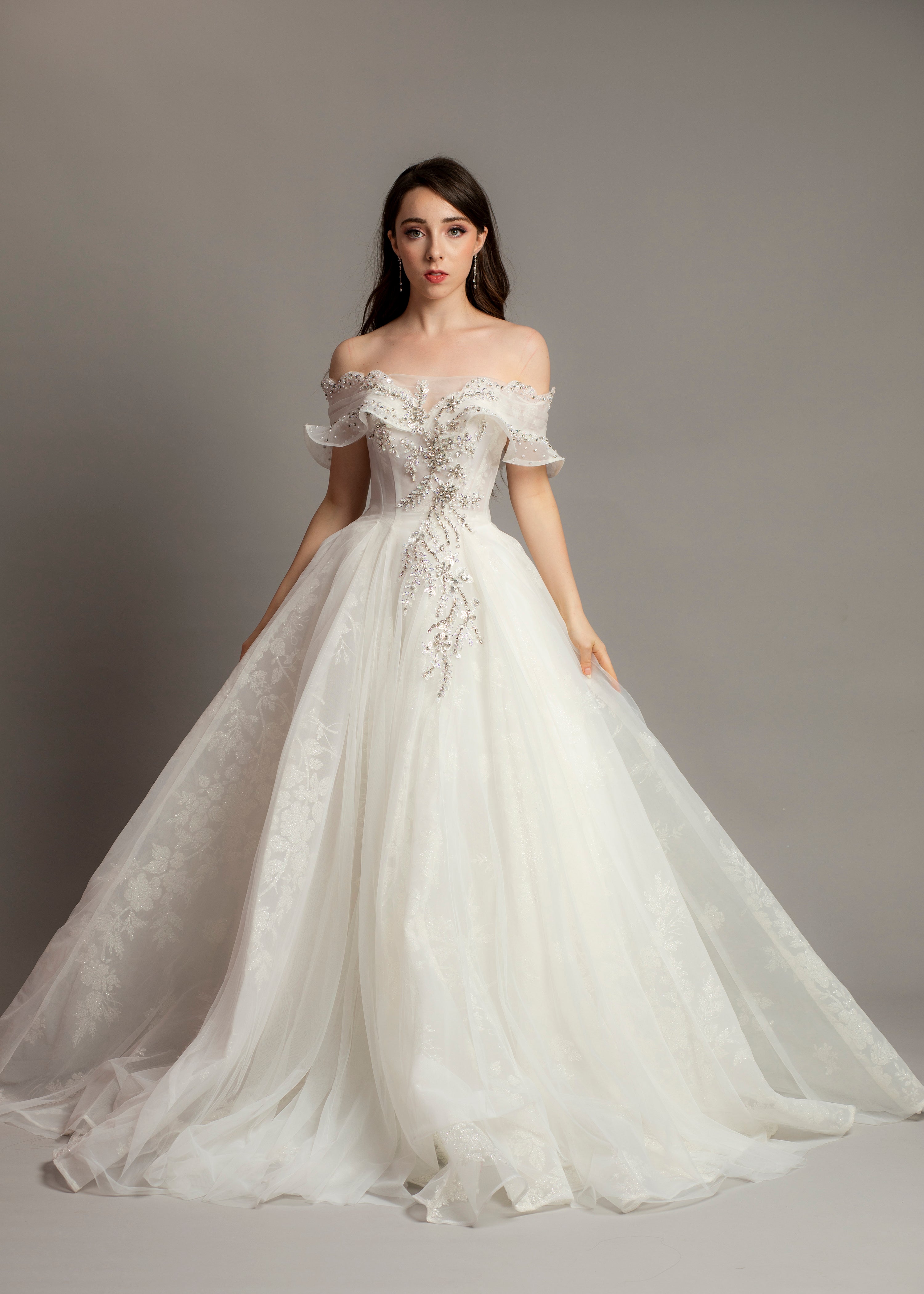 White wedding dress with asymmetrical bustier top and puffy layered sk