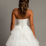 White wedding dress with a bushier top and a bushier puffy layered skirt