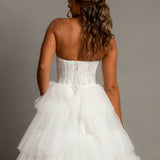 White wedding dress with a bushier top and a bushier puffy layered skirt