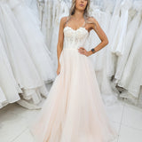 White flowery Bustier cup with a blush tulle skirt.