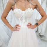 White flowery Bustier cup with a blush tulle skirt for hire