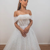 White sequins and beads all over the dress with off the shoulder sleeve