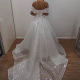 White sequins and beads all over the dress with off the shoulder sleeve