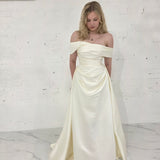 ivory A-line gown with sculpted draping, romantic sleeves, and timeless sophistication.