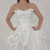 satin and tulle ballgown with cascading ribbons and romantic couture-inspired volume.