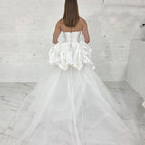 satin and tulle ballgown with cascading ribbons and romantic couture-inspired volume.
