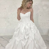 white ballgown with sculptural pleats, layered volume, and timeless couture elegance