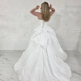 white ballgown with sculptural pleats, layered volume, and timeless couture elegance