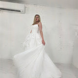 white ballgown with sculptural pleats, layered volume, and timeless couture elegance