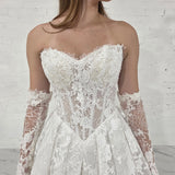 pearl-detailed lace ballgown with ethereal sleeves and regal bridal elegance.