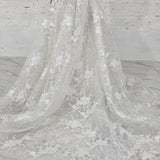 pearl-detailed lace ballgown with ethereal sleeves and regal bridal elegance.