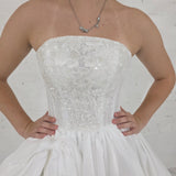 satin wedding gown with sparkling lace, elegant draping, and enchanting peekaboo details for hire