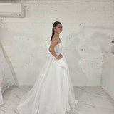 satin wedding gown with sparkling lace, elegant draping, and enchanting peekaboo details for hire