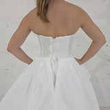 satin wedding gown with sparkling lace, elegant draping, and enchanting peekaboo details for hire