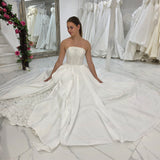 satin wedding gown with sparkling lace, elegant draping, and enchanting peekaboo details for hire
