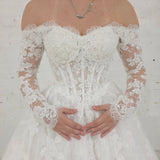 romantic lace ballgown wedding dress featuring off-shoulder sleeves, exposed boning, and timeless elegance