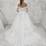 romantic lace ballgown wedding dress featuring off-shoulder sleeves, exposed boning, and timeless elegance