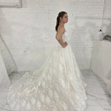 sparkling ivory lace wedding dress featuring a sweetheart neckline, corset back, and romantic ballgown silhouette