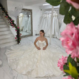 sparkling ivory lace wedding dress featuring a sweetheart neckline, corset back, and romantic ballgown silhouette