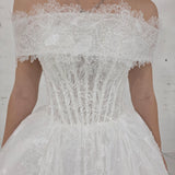 romantic white ballgown wedding dress adorned with floral lace, pearls, sparkle, and timeless elegance