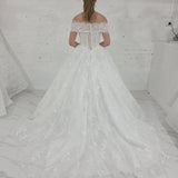 romantic white ballgown wedding dress adorned with floral lace, pearls, sparkle, and timeless elegance