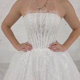 romantic white ballgown wedding dress adorned with floral lace, pearls, sparkle, and timeless elegance