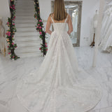 white A-line wedding dress featuring floral beaded lace, Chantilly lace, a basque waist, and corset elegance.
