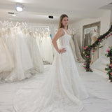 white A-line wedding dress featuring floral beaded lace, Chantilly lace, a basque waist, and corset elegance.
