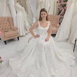 white A-line wedding dress featuring floral beaded lace, Chantilly lace, a basque waist, and corset elegance.
