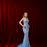 Blue mermaid gown with dazzling beadwork and an elegant silhouette.