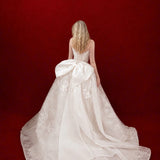 ballgown wedding dress with floral lace and dramatic detachable bow
