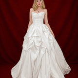 white ballgown with sculptural pleats, layered volume, and timeless couture elegance