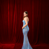 Blue mermaid gown with dazzling beadwork and an elegant silhouette.
