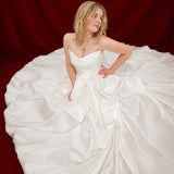 white ballgown with sculptural pleats, layered volume, and timeless couture elegance