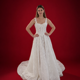 white A-line wedding dress featuring floral beaded lace, Chantilly lace, a basque waist, and corset elegance.