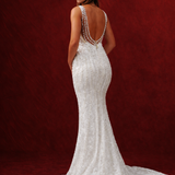 mermaid gown with beaded fabric, low back, buttons, and train.