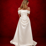 ivory A-line gown with sculpted draping, romantic sleeves, and timeless sophistication.