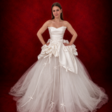 satin and tulle ballgown with cascading ribbons and romantic couture-inspired volume.