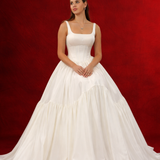 white wedding ballgown with straight neckline, basque waist, corset back, and layered skirt.