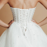White sparkling corset princess dress with basque waist