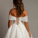 White sequins and beads all over the dress with off the shoulder sleeve