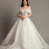 White wedding dress with asymmetrical bustier top and puffy layered skirt