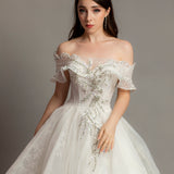 White wedding dress with asymmetrical bustier top and puffy layered skirt