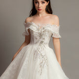 White wedding dress with asymmetrical bustier top and puffy layered skirt