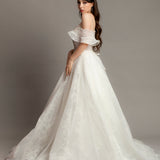 White wedding dress with asymmetrical bustier top and puffy layered skirt