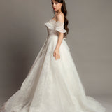 White wedding dress with asymmetrical bustier top and puffy layered skirt