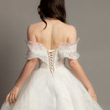 White wedding dress with asymmetrical bustier top and puffy layered skirt