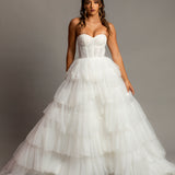 White wedding dress with a bushier top and a bushier puffy layered skirt