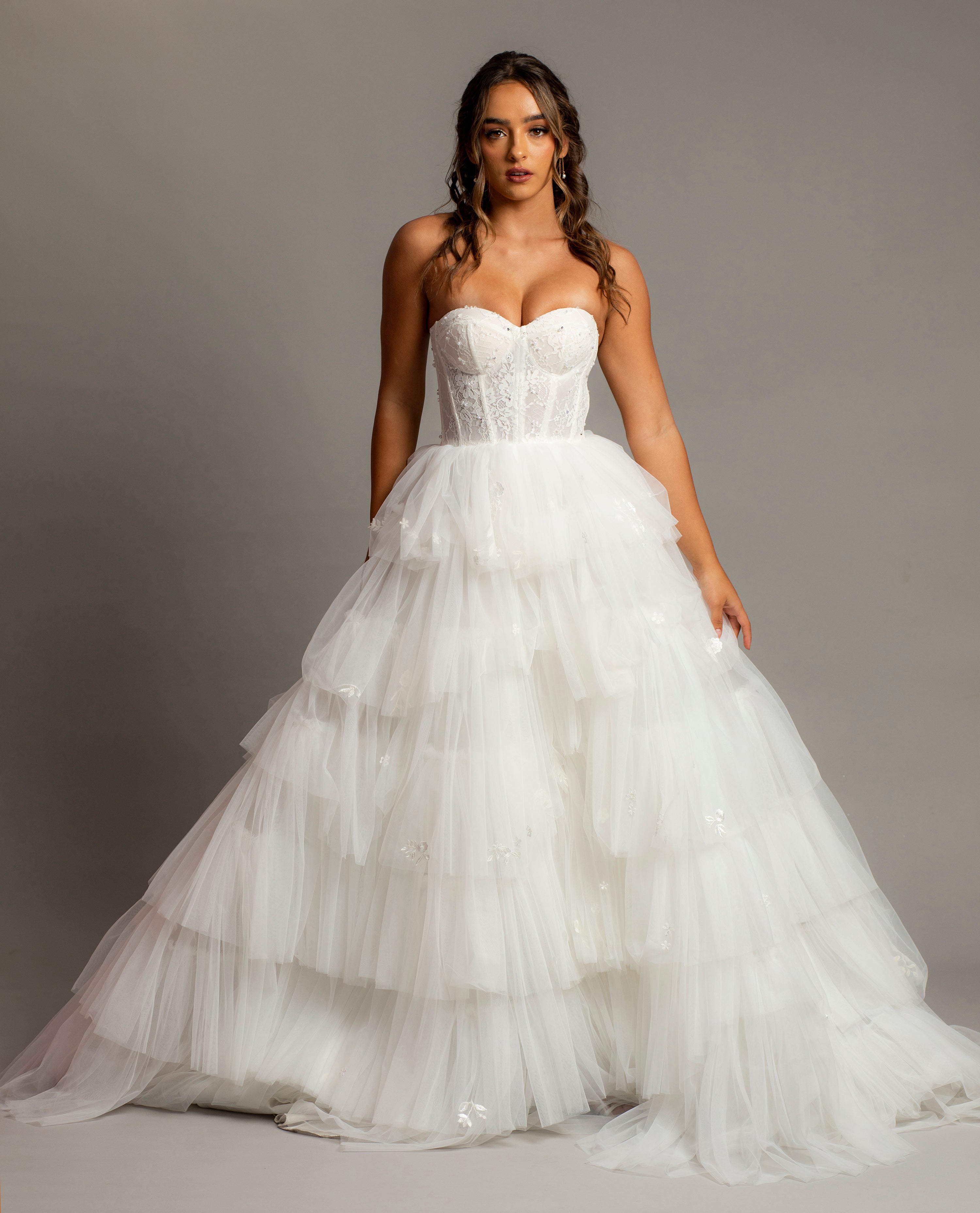 White wedding dress with a bushier top and a bushier puffy layered