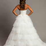 White wedding dress with a bushier top and a bushier puffy layered skirt